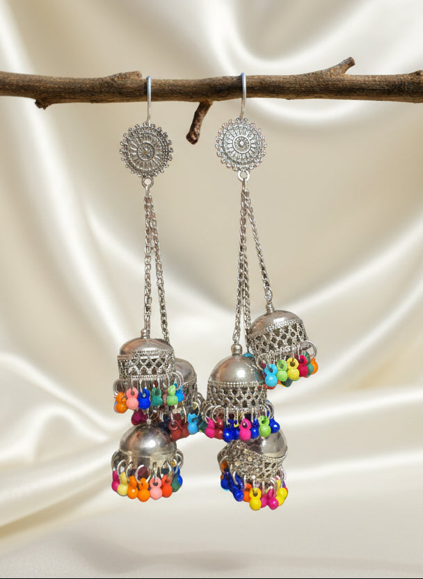 Colorful silver jhumka earrings with vibrant bead accents, perfect for bohemian style jewelry.