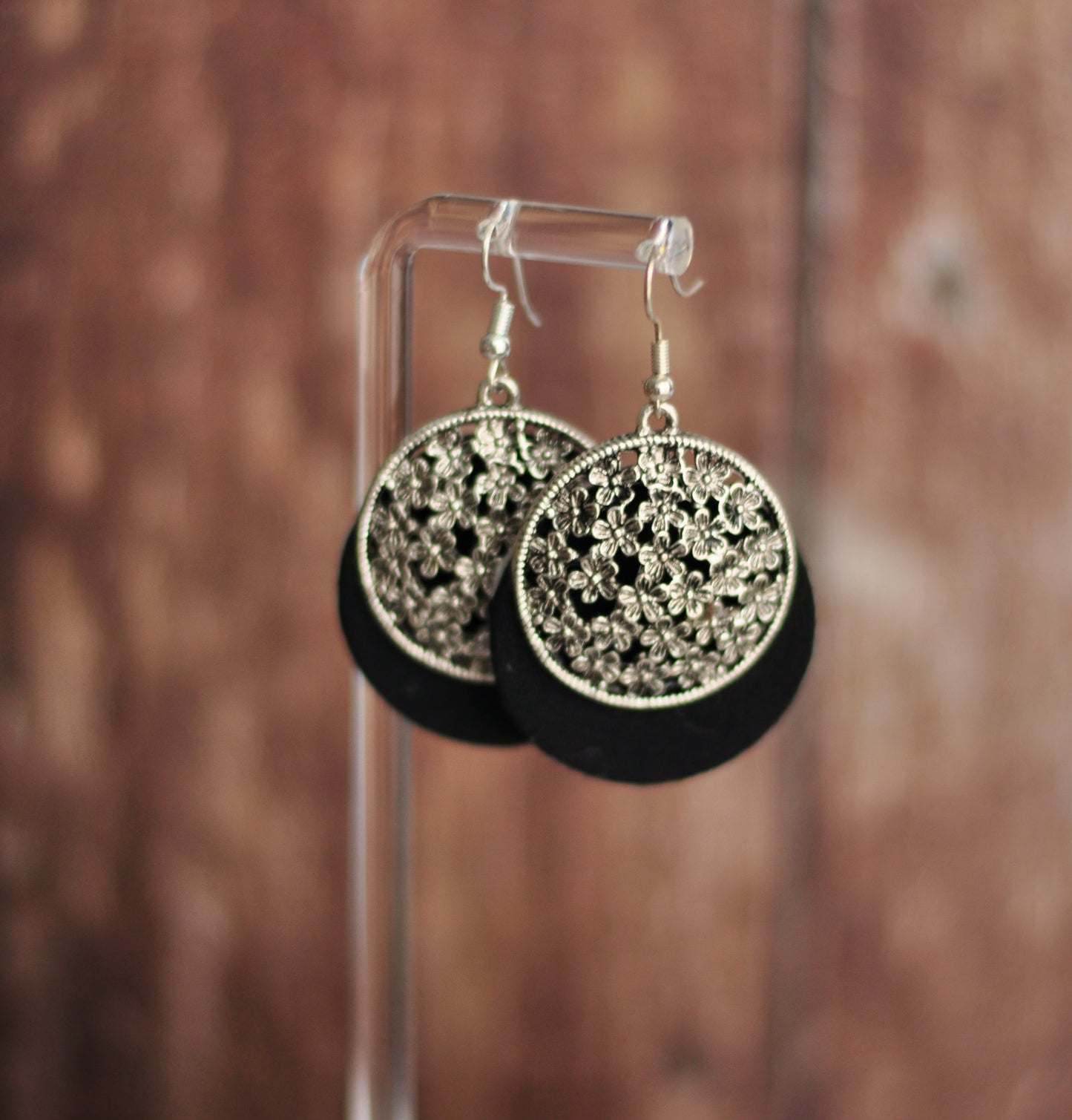 Black and silver floral design earrings made from metal and fabric, featuring a chic bohemian style.