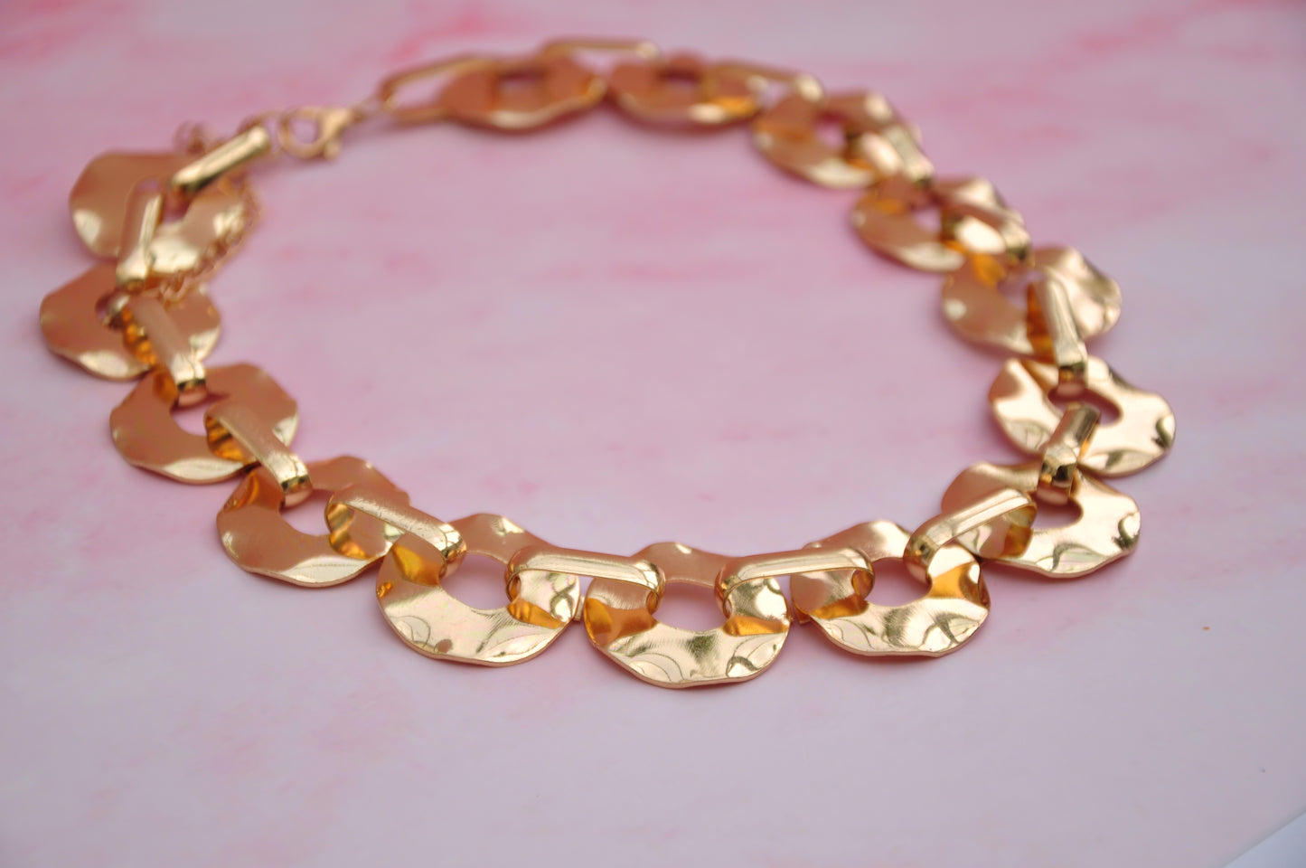 Elegant gold chain bracelet with hammered links, perfect for casual or formal occasions.