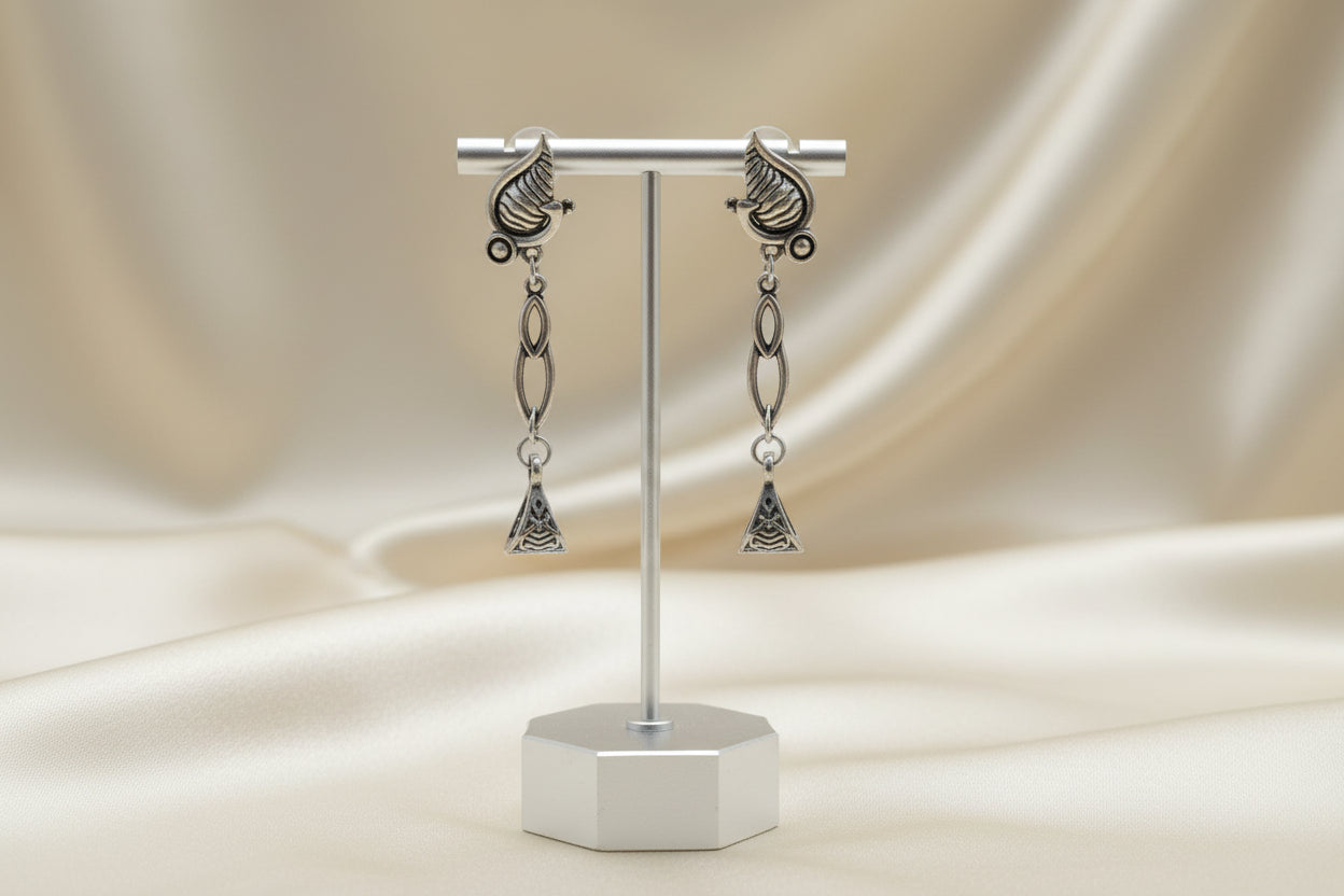 Elegant silver drop earrings with seashell and triangle design, perfect for beach-themed accessories.