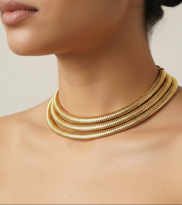 Elegant gold choker necklace with layered design, crafted from high-quality metal.
