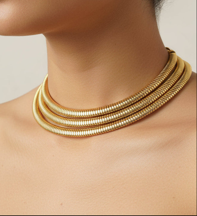 Elegant gold choker necklace with layered design, crafted from high-quality metal.