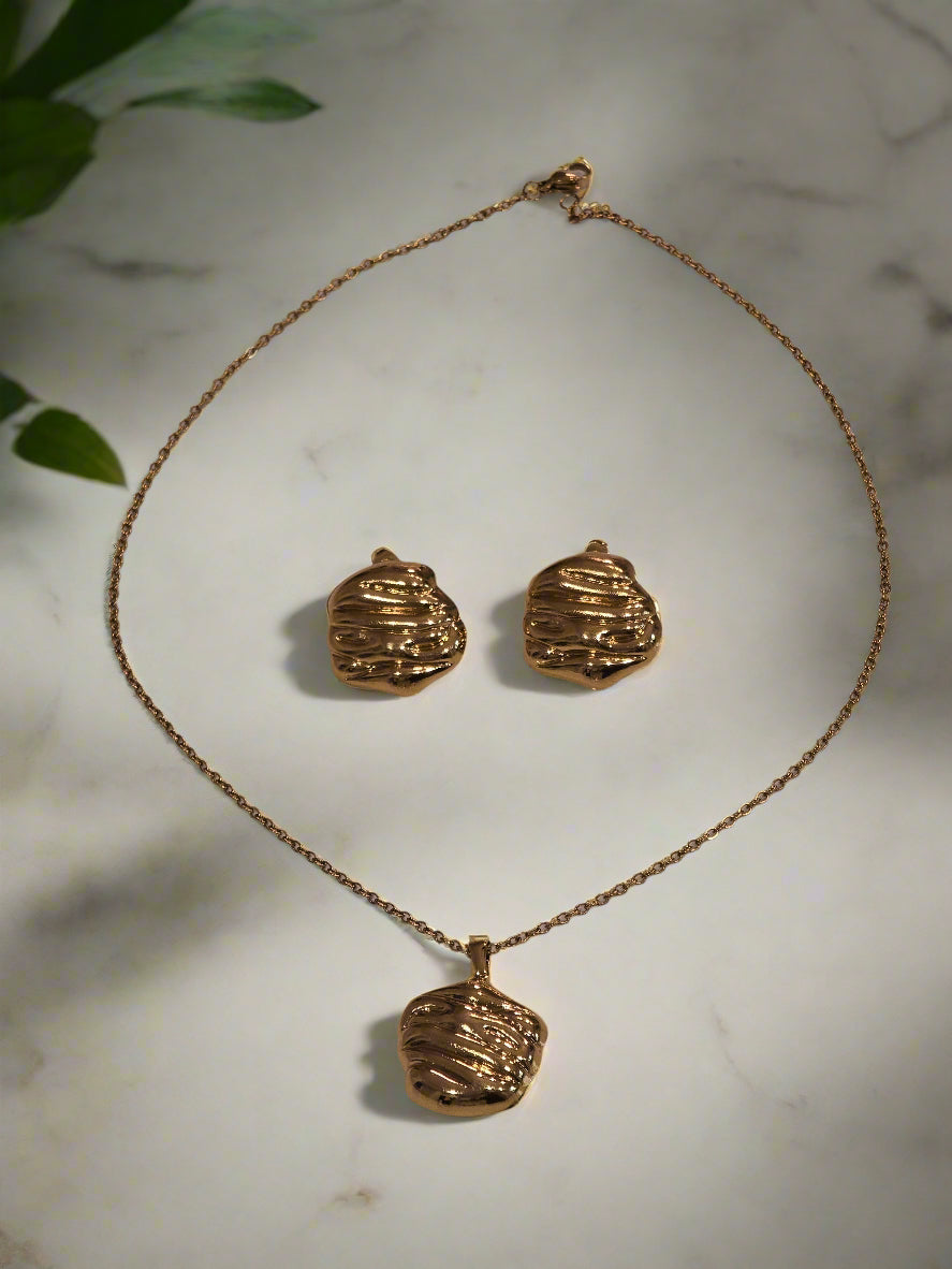 Elegant gold-tone necklace and earrings set with textured design, perfect for any special occasion.