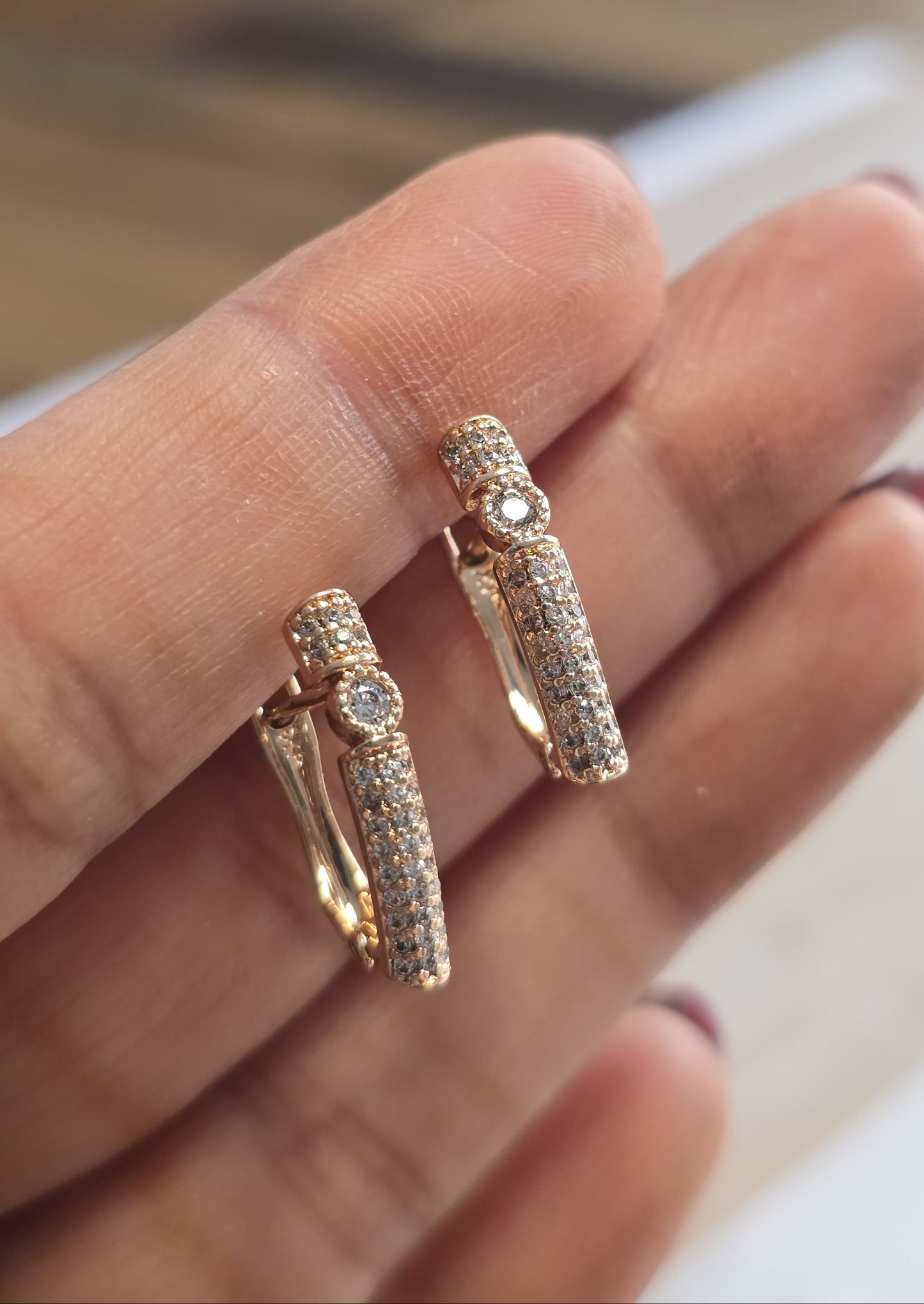Elegant gold-tone hoop earrings with sparkling crystals, perfect for any occasion.