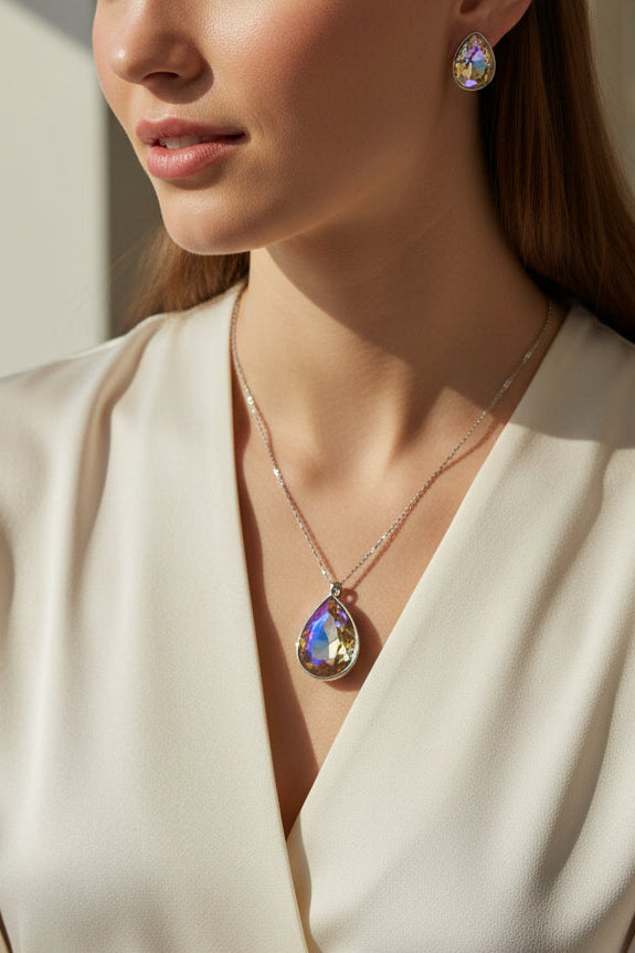 Elegant silver jewelry set featuring a colorful teardrop pendant and matching earrings, perfect for any occasion.