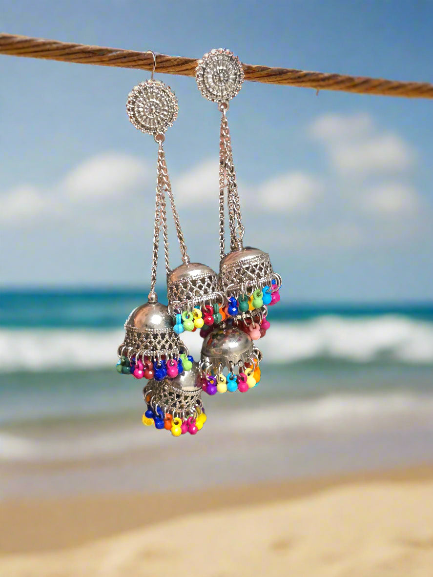 Colorful silver jhumka earrings with intricate design and vibrant bead accents, perfect for festive occasions.