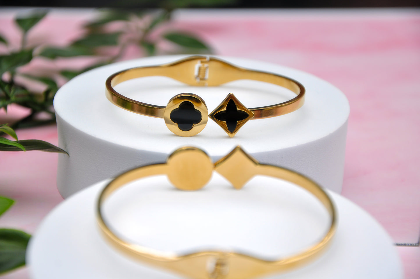 Elegant gold cuff bracelets with black enamel geometric accents, perfect for stylish layering.