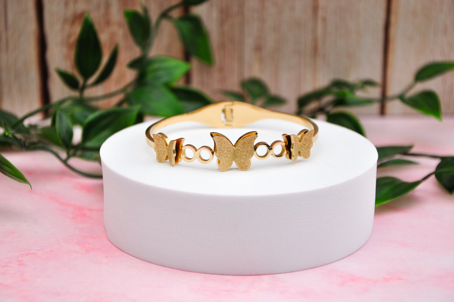 Elegant gold butterfly bracelet, made of metal with intricate detailing and contemporary design.