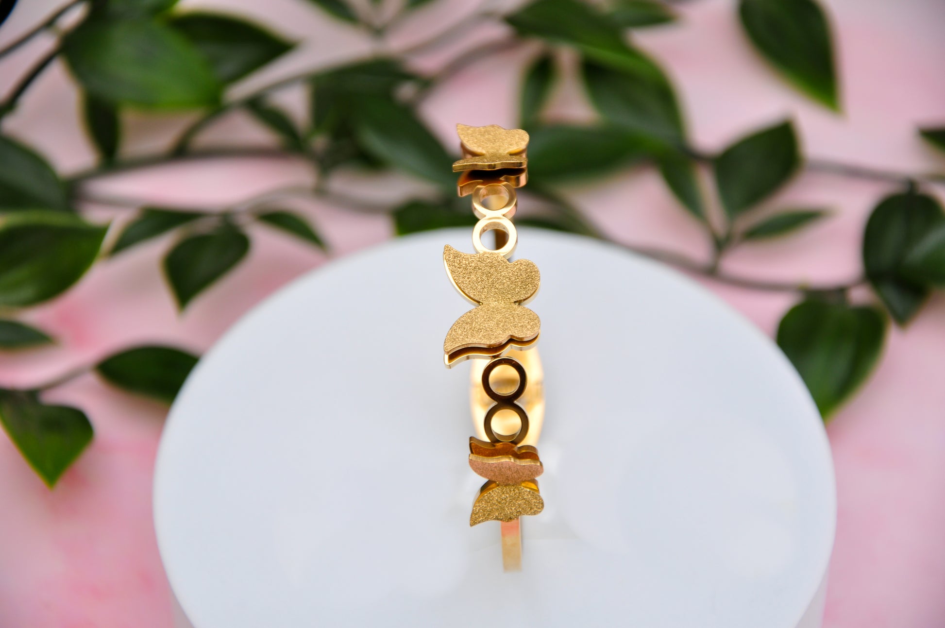 Gold butterfly bracelet with intricate design, perfect for adding a touch of elegance to any outfit.