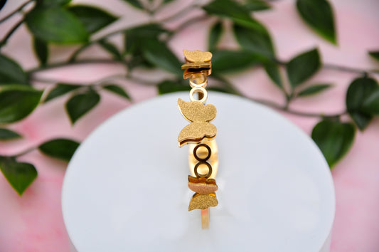 Gold butterfly bracelet with intricate design, perfect for adding a touch of elegance to any outfit.