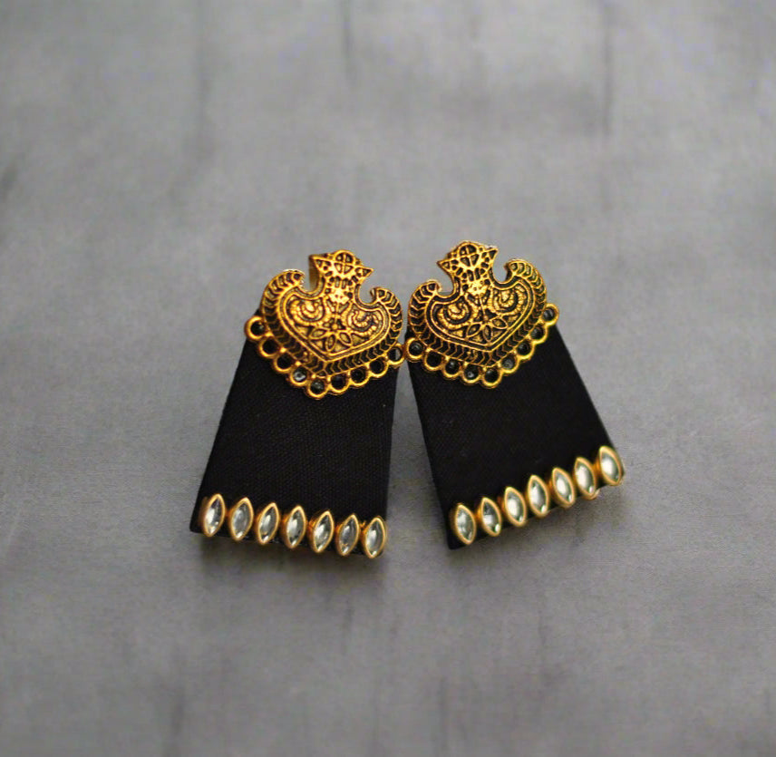 Elegant black earrings with gold filigree design and crystal accents, perfect for special occasions.