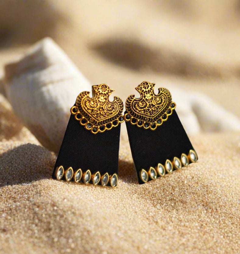 Black geometric earrings with gold detailing and sparkling gems, perfect for elegant occasions.