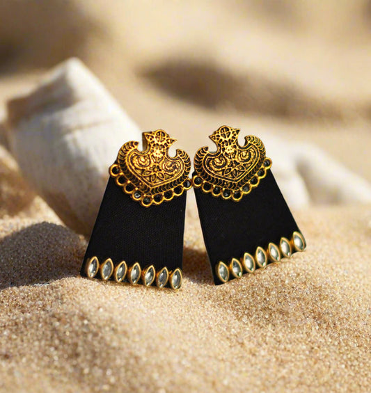 Black geometric earrings with gold detailing and sparkling gems, perfect for elegant occasions.