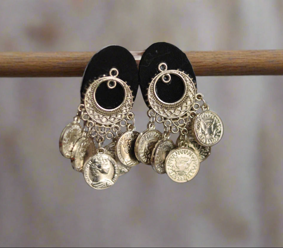 Stylish gold coin earrings with intricate metalwork and black fabric backing, perfect for adding elegance.