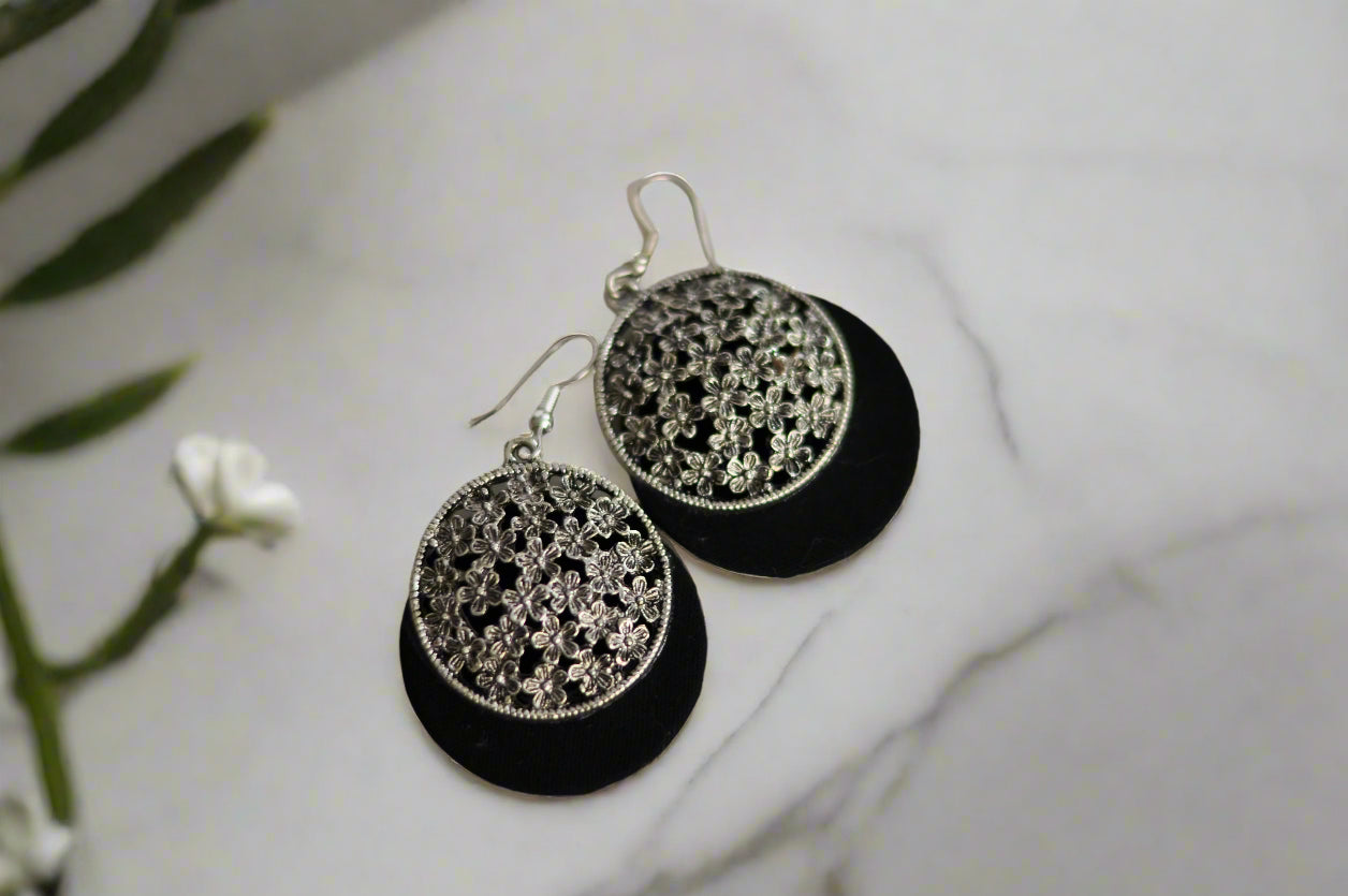 Elegant black and silver floral earrings made of metal and suede, perfect for any occasion.