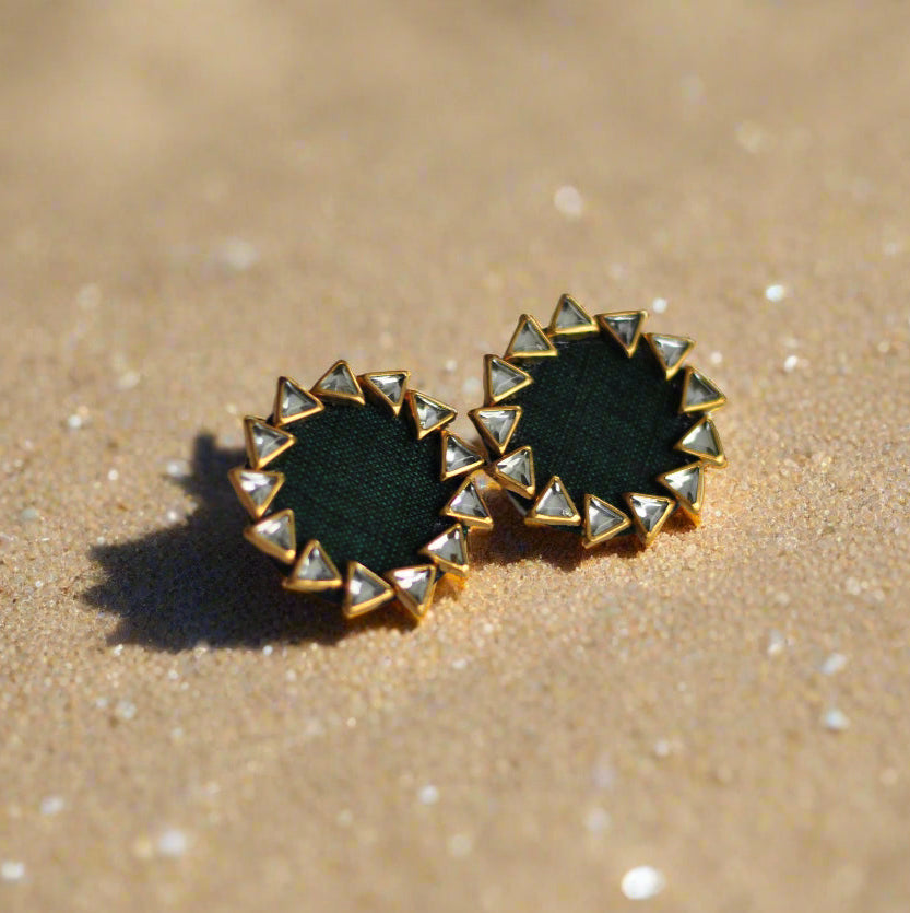 Green fabric stud earrings with gold detailing and triangle-shaped accents.