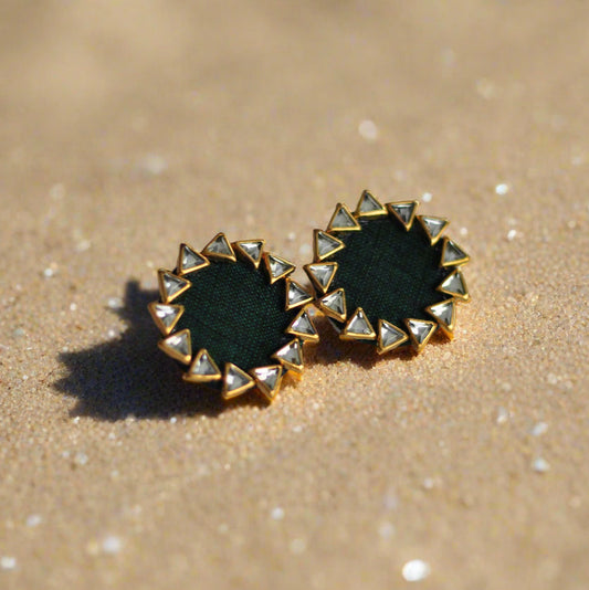 Green fabric stud earrings with gold detailing and triangle-shaped accents.