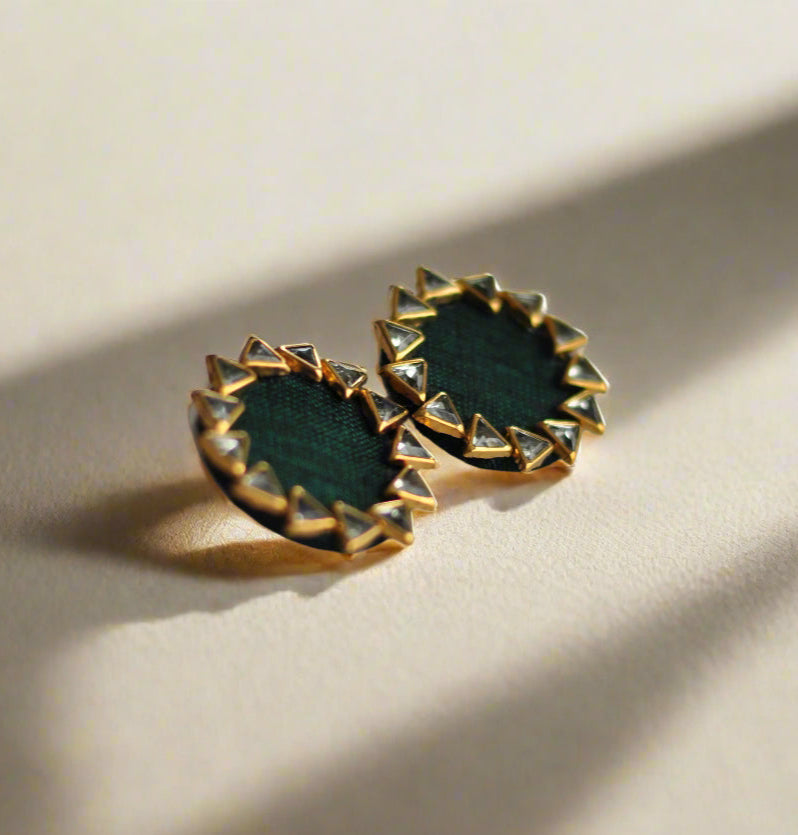 Green gemstone stud earrings with gold spike detailing, perfect for stylish accessories.