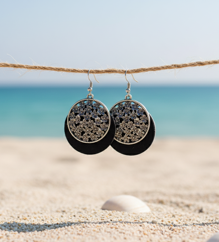 Stylish black drop earrings with floral silver accents, perfect for beach or casual wear.
