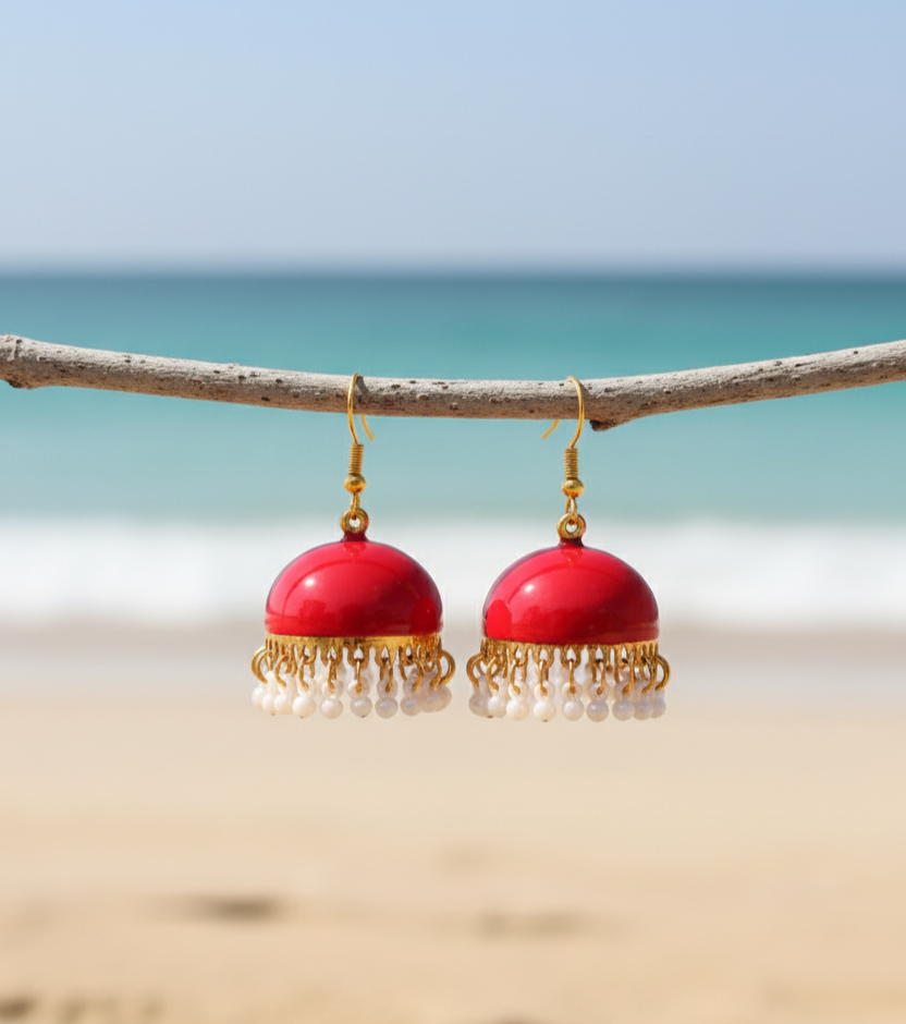 Red handmade earrings with gold accents and pearl tassels, perfect for beachwear accessories.