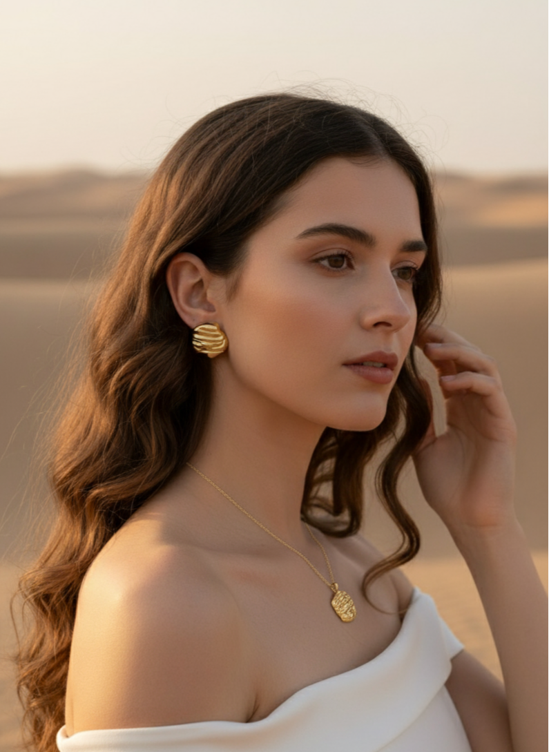 Elegant gold jewelry set featuring textured earrings and a matching necklace, perfect for stylish outfits.