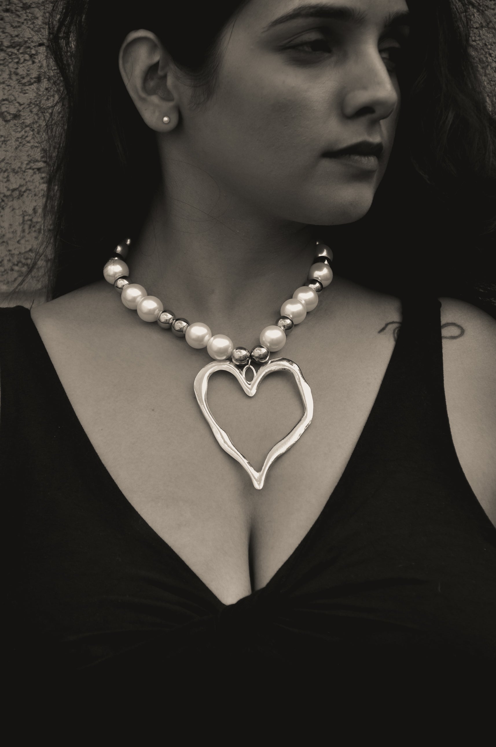 Stylish heart-shaped silver pendant necklace with pearls, perfect for elegant looks.