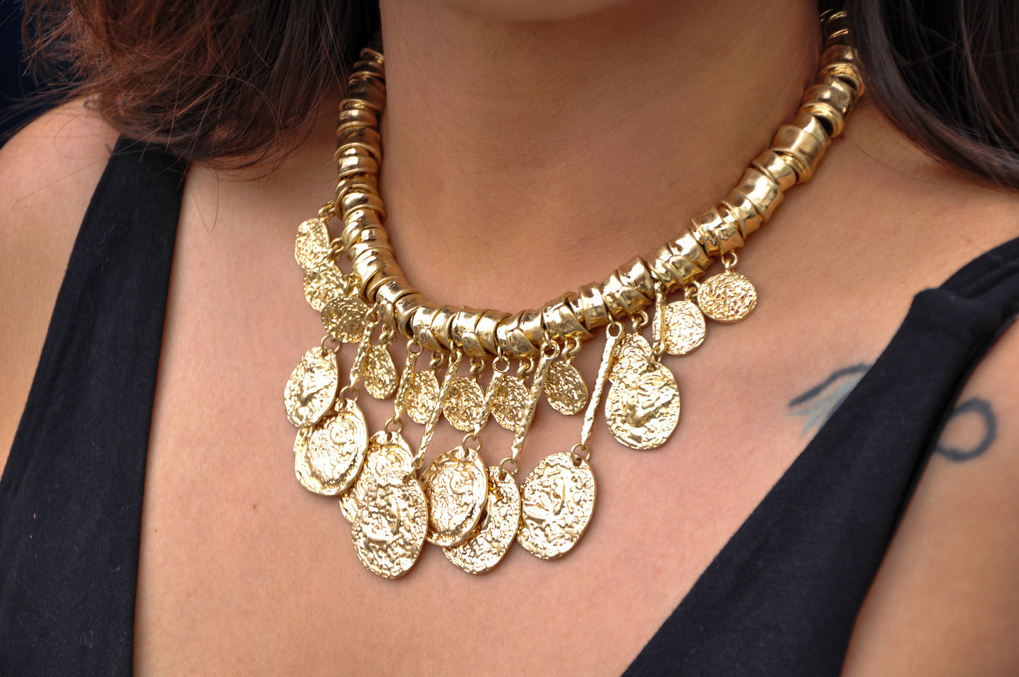 Gold statement necklace with coin pendants and beaded design for bold fashion statements.