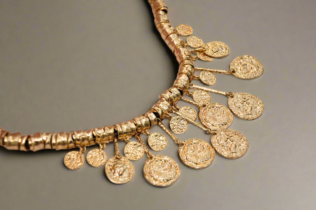 Elegant gold coin necklace with detailed pendants and textured beads, perfect for any occasion.