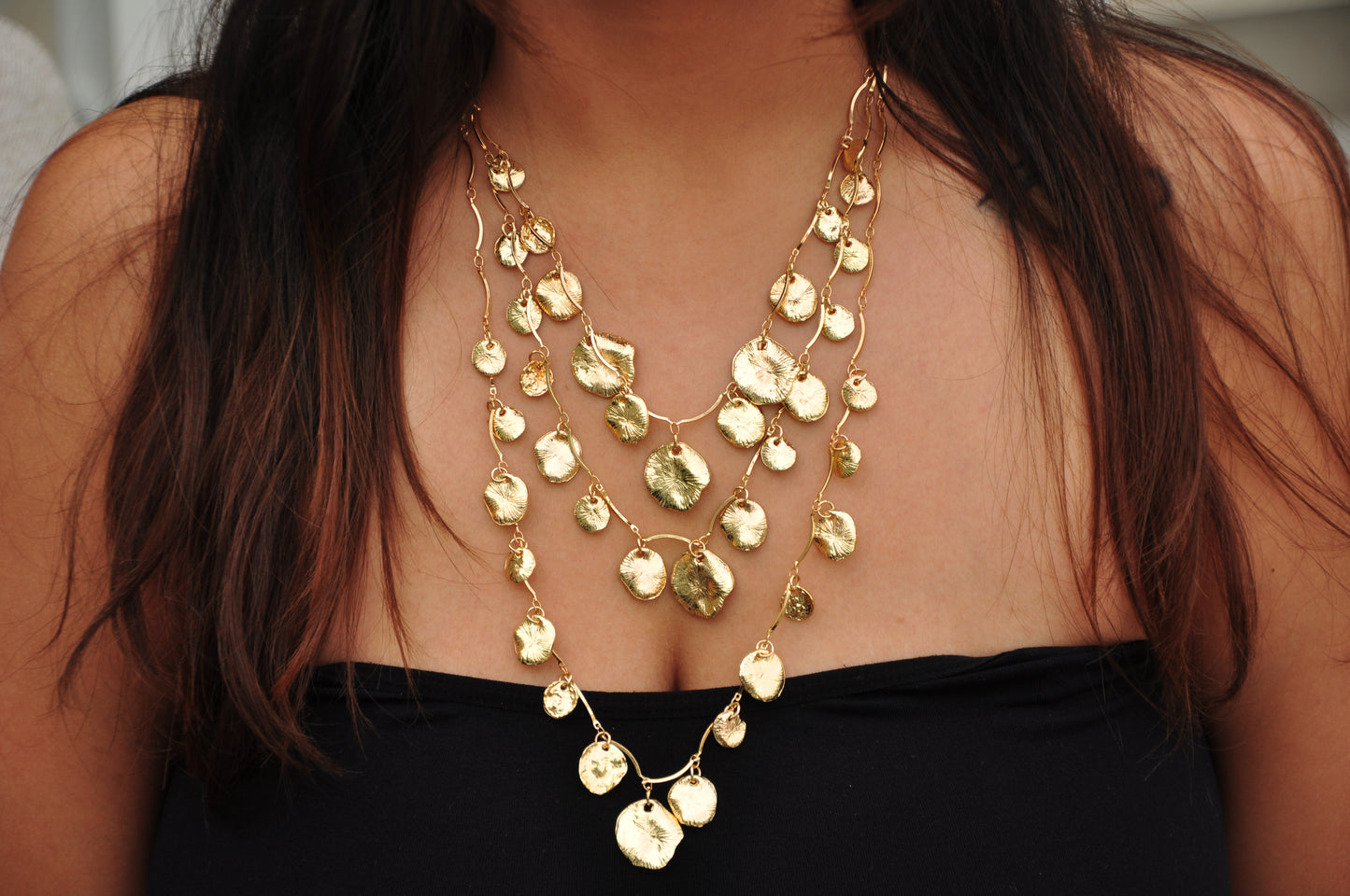 Elegant gold layered necklace with leaf-shaped pendants, perfect for casual and formal outfits.