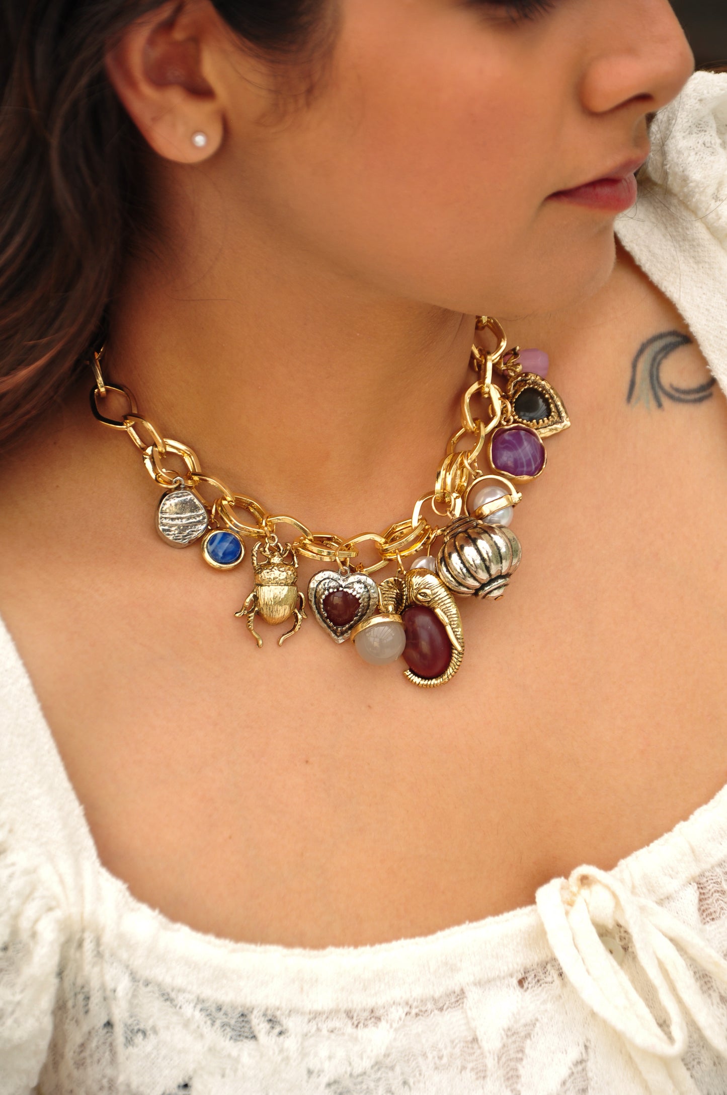 Gold chain necklace with colorful charms, including hearts, animals, and gemstones, perfect for statement jewelry.