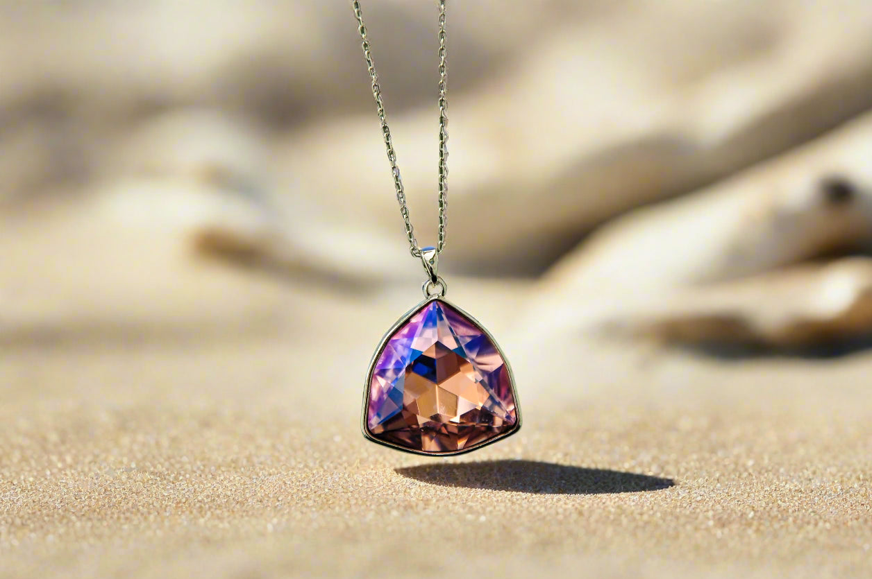 Elegant triangle pendant necklace featuring a pink-purple crystal, perfect for stylish occasions.