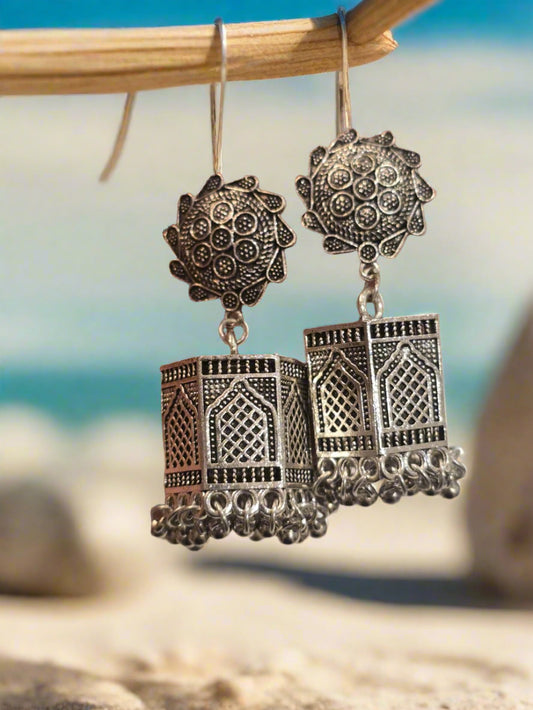 Handcrafted silver earrings with intricate patterns and floral design, perfect for a stylish look.