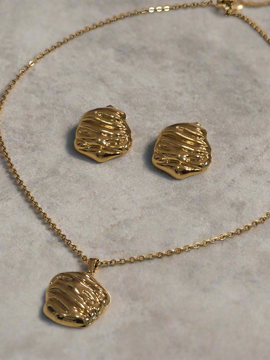 Gold necklace and matching earrings set with textured design, perfect for elegant occasions.