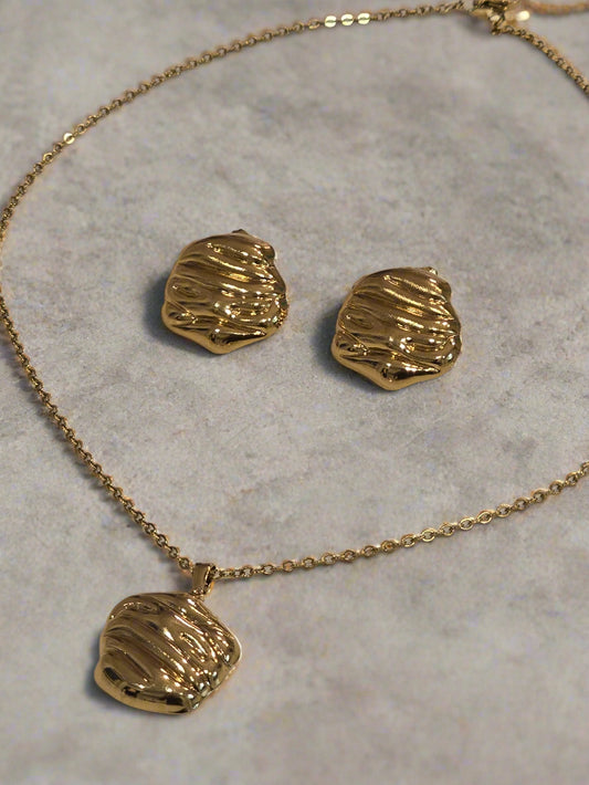 Gold necklace and matching earrings set with textured design, perfect for elegant occasions.
