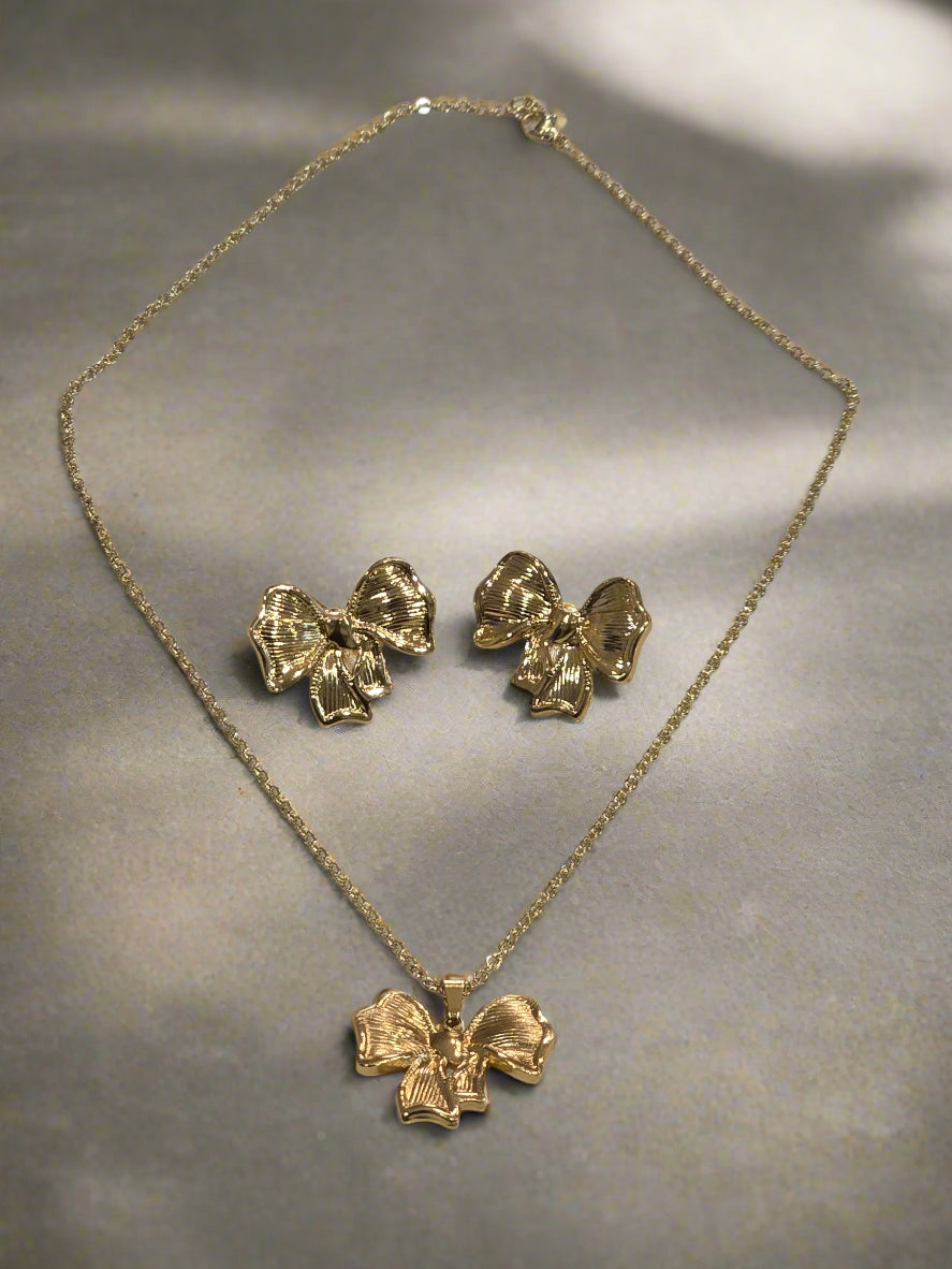 Gold floral jewelry set featuring a necklace and matching earrings, crafted with elegant bow designs.