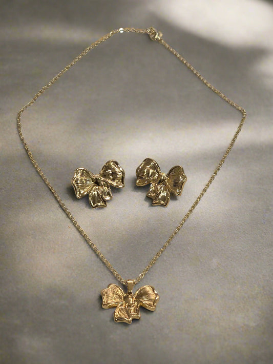 Gold floral jewelry set featuring a necklace and matching earrings, crafted with elegant bow designs.