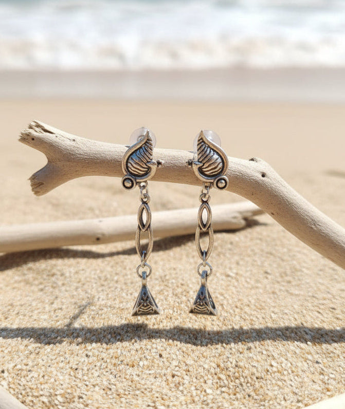 Elegant silver drop earrings with seashell and triangle design, perfect for beach-themed accessories.