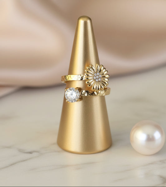 Gold ring with gemstones on a neutral background and golden ring stand