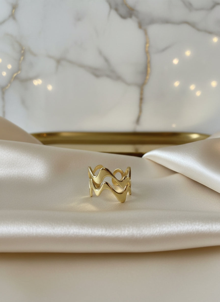Gold wave ring made of durable metal, featuring an elegant wavy design, perfect for stacking or everyday wear.