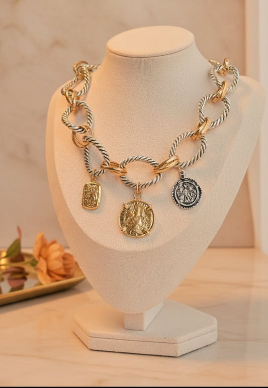 Gold and silver chain necklace featuring ornate pendants, perfect for statement jewelry.