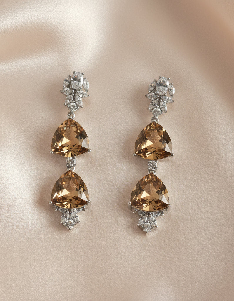 Stunning brown crystal drop earrings with silver embellishments, perfect for elegant occasions.