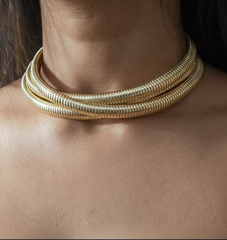 Gold statement choker necklace with layered spiral design, perfect for elegant outfits and special occasions.