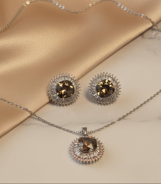 Elegant jewelry set featuring a silver necklace and matching earrings with smoky brown gemstones.