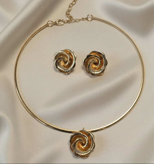 Gold swirl necklace and earrings set, elegant metallic floral design, perfect for special occasions.