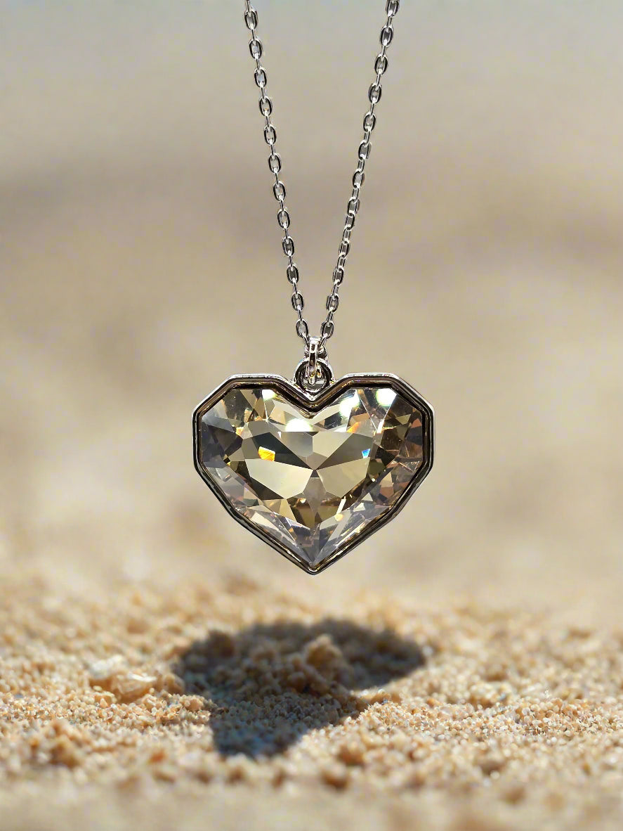 Heart-shaped crystal pendant necklace on a delicate silver chain, perfect for any occasion.