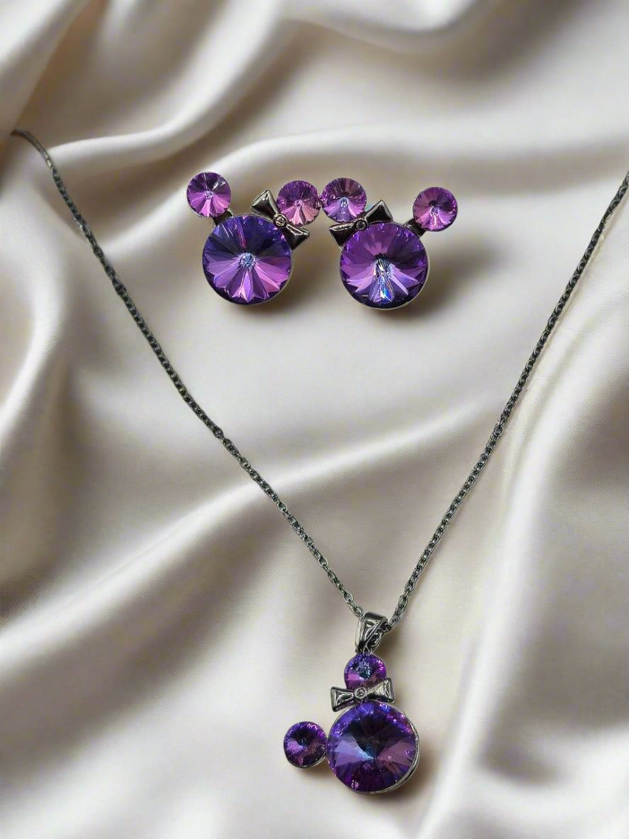 Purple crystal necklace and earrings set with bow detail on silver chain, perfect for stylish accessories.