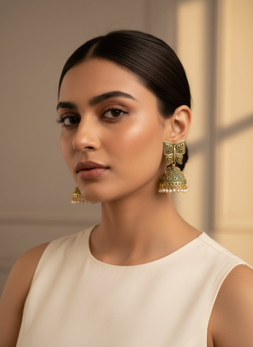 Elegant green butterfly jhumka earrings with intricate designs and pearl accents, perfect for festive occasions.