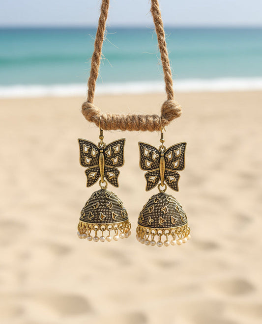 Gold butterfly jhumka earrings with pearl accents, perfect for boho beach style outfits.