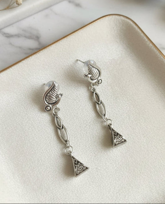 Silver drop earrings with decorative shell and triangular design, perfect for elegant occasions.