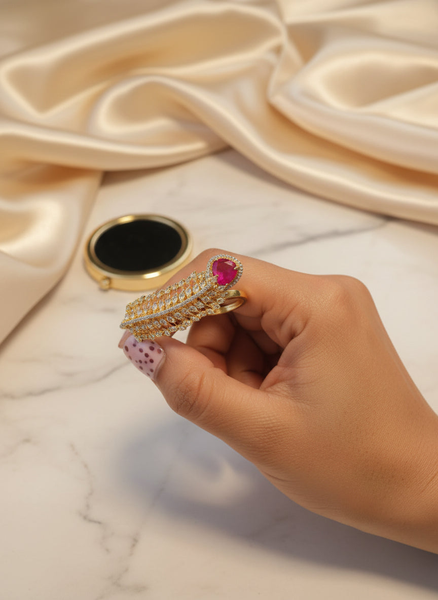 Elegant gold hair clip with a pink gemstone and intricate leaf design, perfect for formal occasions.